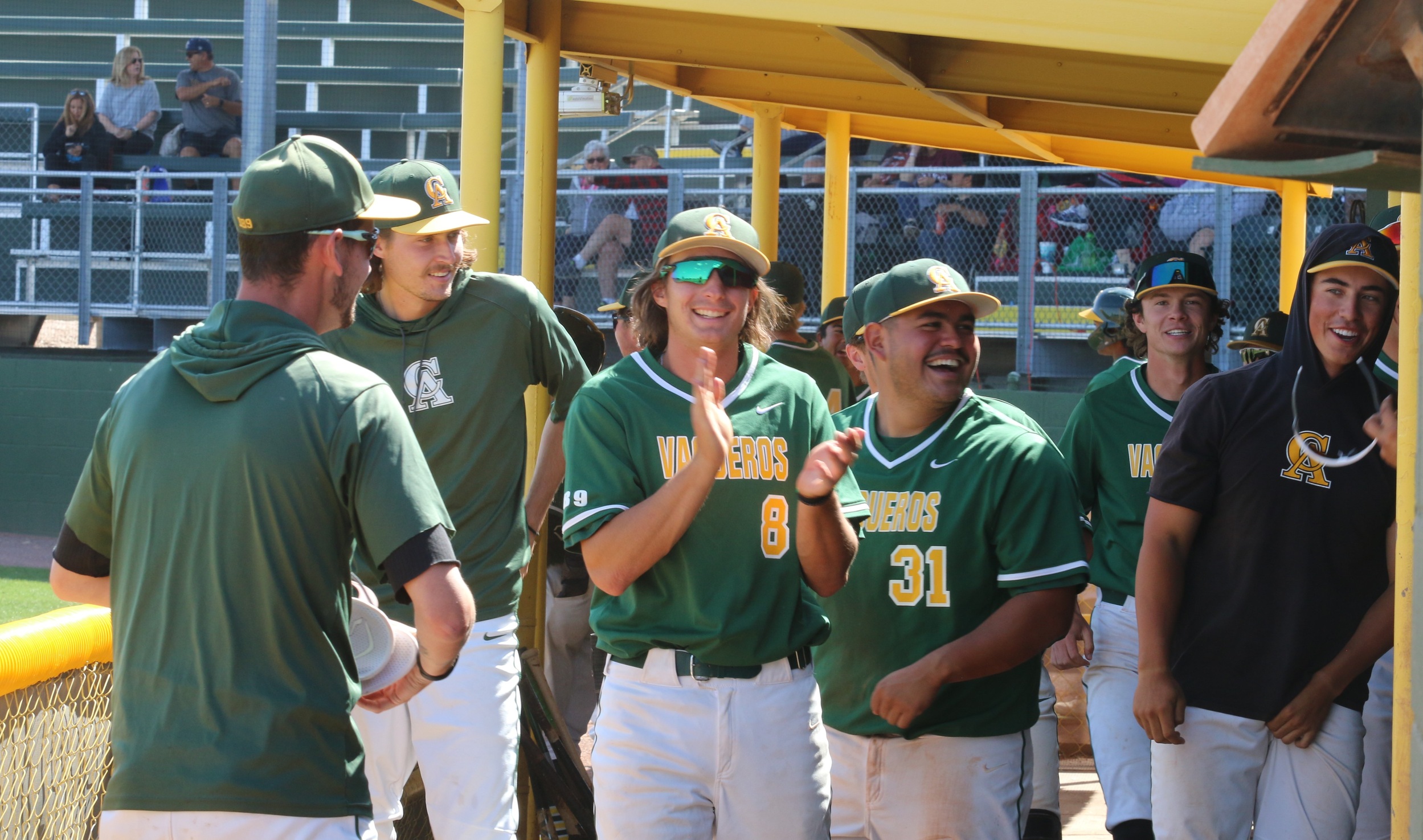 Dugout is happy after pinch-runner Daniel Davila finally touched home plate. It was the sixth run but he missed the plate first time around.