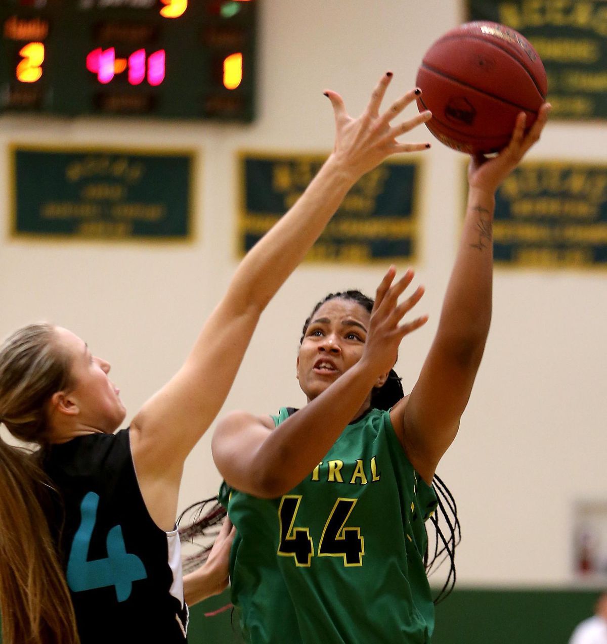 Central's Jerraysha Smith, right, shoots over Chandler Gilbert's Rylee Chapman Wednesday night at George Young Activity Center.